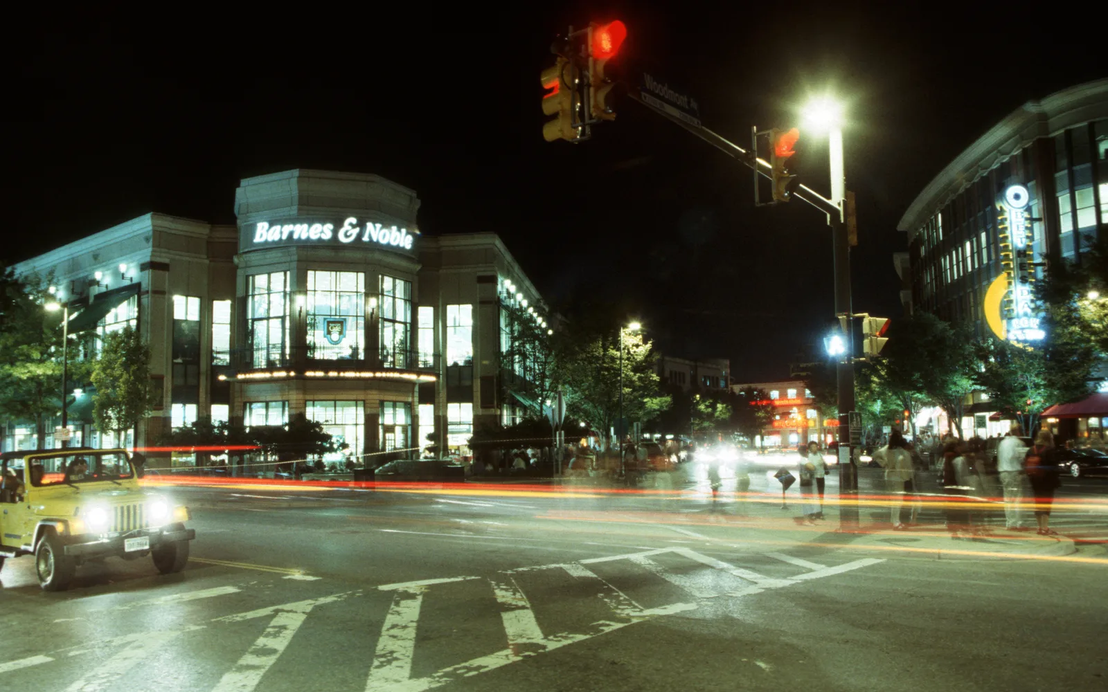 Urban street at night with city buildings and lights